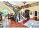 Expansive foyer with a grand staircase, bright yellow walls, and hardwood floors at 11557 Willow Springs Dr, Zionsville, IN 46077