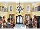 Grand foyer showcasing chandelier, high ceilings, hardwood floors, and double front doors at 11557 Willow Springs Dr, Zionsville, IN 46077