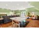 Spacious game room features a ping pong table, wood floors, and comfortable seating area at 11557 Willow Springs Dr, Zionsville, IN 46077