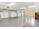 Spacious three-car garage featuring epoxy flooring and ample overhead storage at 11557 Willow Springs Dr, Zionsville, IN 46077