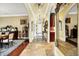 Long hallway boasts decorative archways, wood flooring, and natural light at 11557 Willow Springs Dr, Zionsville, IN 46077