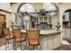 Arched entryway and granite countertops highlight the eat-in kitchen with stainless steel appliances and custom cabinets at 11557 Willow Springs Dr, Zionsville, IN 46077