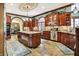 Spacious kitchen features an island with granite countertops, abundant cabinetry, and modern stainless steel appliances at 11557 Willow Springs Dr, Zionsville, IN 46077