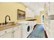 Well-equipped laundry room featuring modern appliances and ample storage space at 11557 Willow Springs Dr, Zionsville, IN 46077
