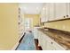 Bright laundry room with granite counters and plentiful storage at 11557 Willow Springs Dr, Zionsville, IN 46077