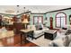 Open-concept living space featuring hardwood floors, ample lighting, and comfortable seating arrangement at 11557 Willow Springs Dr, Zionsville, IN 46077