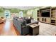 Large living room featuring a sectional sofa, a built-in entertainment center, and hardwood floors at 11557 Willow Springs Dr, Zionsville, IN 46077
