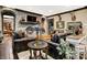 A brick fireplace and leather seating highlight this cozy living room with a patterned rug and mounted deer heads at 11557 Willow Springs Dr, Zionsville, IN 46077