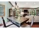 Inviting living area featuring a stone fireplace, hardwood floors, and arched windows at 11557 Willow Springs Dr, Zionsville, IN 46077