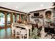 An arched brick fireplace, leather sofas, and beamed ceiling enhance this cozy living room with bar-stool seating at 11557 Willow Springs Dr, Zionsville, IN 46077