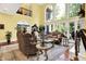 Living room featuring high ceilings, ornate furnishings, and floor to ceiling windows at 11557 Willow Springs Dr, Zionsville, IN 46077
