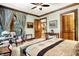 Luxurious main bedroom featuring custom curtains, wood trim, and cozy seating area at 11557 Willow Springs Dr, Zionsville, IN 46077