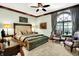 Inviting main bedroom with stylish furnishings, a ceiling fan, and an arched window at 11557 Willow Springs Dr, Zionsville, IN 46077