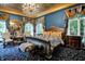 Luxurious primary bedroom with a gold ceiling, king bed, and large windows at 11557 Willow Springs Dr, Zionsville, IN 46077