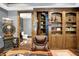 Office view highlighting custom built-ins, interior access to spiral staircase, and hardwood floors at 11557 Willow Springs Dr, Zionsville, IN 46077