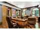 Sophisticated office featuring a detailed desk, wood floors, and arched windows at 11557 Willow Springs Dr, Zionsville, IN 46077