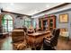 Spacious home office showcasing a refined desk, wood floors, and built-in display cases at 11557 Willow Springs Dr, Zionsville, IN 46077