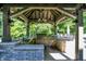 Enjoy outdoor cooking in this well-equipped kitchen with a built-in grill, sink, and ample counter space and view at 11557 Willow Springs Dr, Zionsville, IN 46077