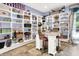 Room with custom shelving, decor, and a small table with seating at 11557 Willow Springs Dr, Zionsville, IN 46077