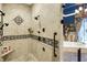 Walk in shower featuring stylish tile work, and black and tan accents, next to the soaking tub and chandelier at 11557 Willow Springs Dr, Zionsville, IN 46077