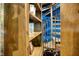 Unique view of a spiral staircase adjacent to a custom bookcase and blue accent wall at 11557 Willow Springs Dr, Zionsville, IN 46077