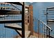 Close-up of a spiral staircase leading to a room with an eclectic firearm and sword collection at 11557 Willow Springs Dr, Zionsville, IN 46077