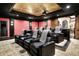 Private home theater boasts comfortable seating, a projector screen, and sophisticated ambiance at 11557 Willow Springs Dr, Zionsville, IN 46077