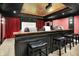 Home theater features tiered seating, a bar, and a projector for an immersive viewing experience at 11557 Willow Springs Dr, Zionsville, IN 46077