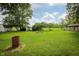 This property has a large, grassy backyard with a shed and mature trees at 1217 S Post Rd, Indianapolis, IN 46239