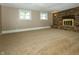 Spacious basement featuring a classic brick fireplace and neutral carpeting at 1217 S Post Rd, Indianapolis, IN 46239