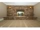 Basement featuring brick fireplace, sconces, and neutral carpeting throughout at 1217 S Post Rd, Indianapolis, IN 46239