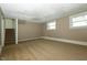 Inviting finished basement with stairs, carpeted flooring, and natural light at 1217 S Post Rd, Indianapolis, IN 46239