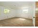 This bedroom has neutral carpet, two windows, and white walls with white trim at 1217 S Post Rd, Indianapolis, IN 46239