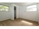 Cozy bedroom featuring neutral carpeting, closet, and two windows for natural light at 1217 S Post Rd, Indianapolis, IN 46239
