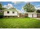 Inviting split-level home with brick accents and a lush green lawn, showcasing its curb appeal at 1217 S Post Rd, Indianapolis, IN 46239