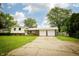 Charming two-story home with a spacious two-car garage and a well-maintained front lawn under a blue sky at 1217 S Post Rd, Indianapolis, IN 46239