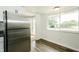 Bright eat-in kitchen with stainless steel refrigerator and view to the exterior at 1217 S Post Rd, Indianapolis, IN 46239