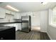 Well-lit kitchen featuring stainless steel refrigerator, white cabinets, and sleek countertops at 1217 S Post Rd, Indianapolis, IN 46239