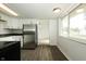 Bright kitchen with white cabinets, stainless steel refrigerator, and view into the dining area at 1217 S Post Rd, Indianapolis, IN 46239