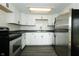 Renovated kitchen featuring stainless steel appliances, subway tile backsplash, and gray wood floors at 1217 S Post Rd, Indianapolis, IN 46239