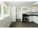 Bright kitchen with white cabinets and stainless steel oven with gray wood floors at 1217 S Post Rd, Indianapolis, IN 46239