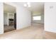 Spacious living area with an open doorway to the kitchen, showcasing modern appliances and finishes at 1217 S Post Rd, Indianapolis, IN 46239