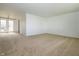 Expansive living area with plush carpeting and double doors leading to a picturesque outdoor space, perfect for entertaining at 1217 S Post Rd, Indianapolis, IN 46239