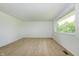 Clean, spacious room featuring neutral carpet, a large window bringing in natural light, and freshly painted walls at 1217 S Post Rd, Indianapolis, IN 46239