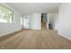 Inviting living space featuring neutral carpeting, stairs to the upper level, and a view of the entry at 1217 S Post Rd, Indianapolis, IN 46239