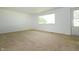 Bright room with neutral carpet, offering a view of the outdoors through a large window near the entry door at 1217 S Post Rd, Indianapolis, IN 46239