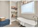 Elegant bathroom featuring a freestanding tub, shelving for storage, and tiled floors at 12839 Bird Cage, Carmel, IN 46032