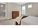 Bright bedroom featuring neutral paint, carpet flooring, and an ensuite bathroom with glass shower at 12839 Bird Cage, Carmel, IN 46032