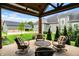 Inviting covered patio with comfortable seating and views of the beautifully landscaped backyard at 12839 Bird Cage, Carmel, IN 46032