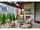 Cozy covered patio with brick fireplace, seating, and outdoor dining area overlooking the yard at 12839 Bird Cage, Carmel, IN 46032